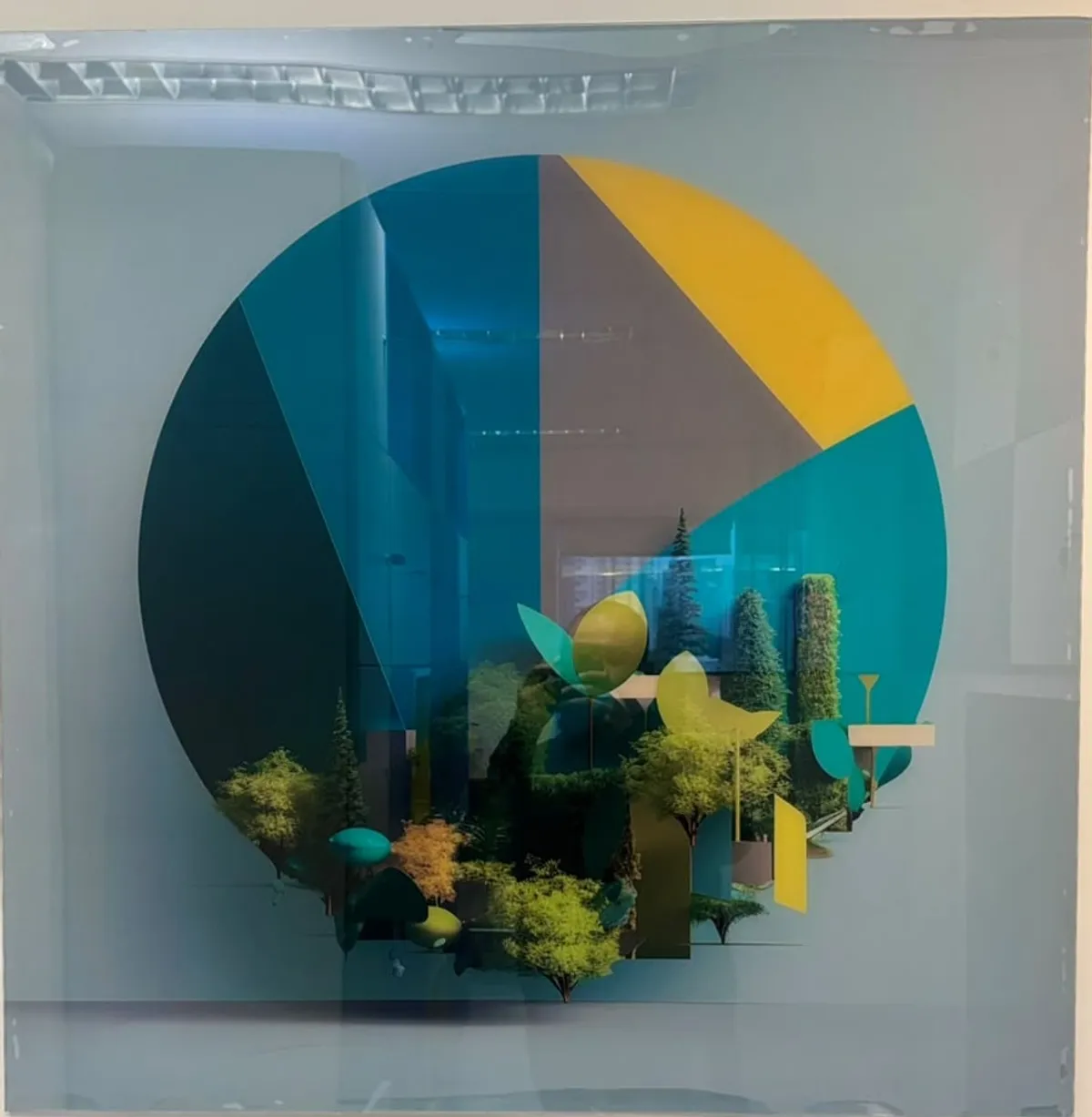 Glass panel in the ILC office: the brand symbol in a circle, on the sustainability theme
